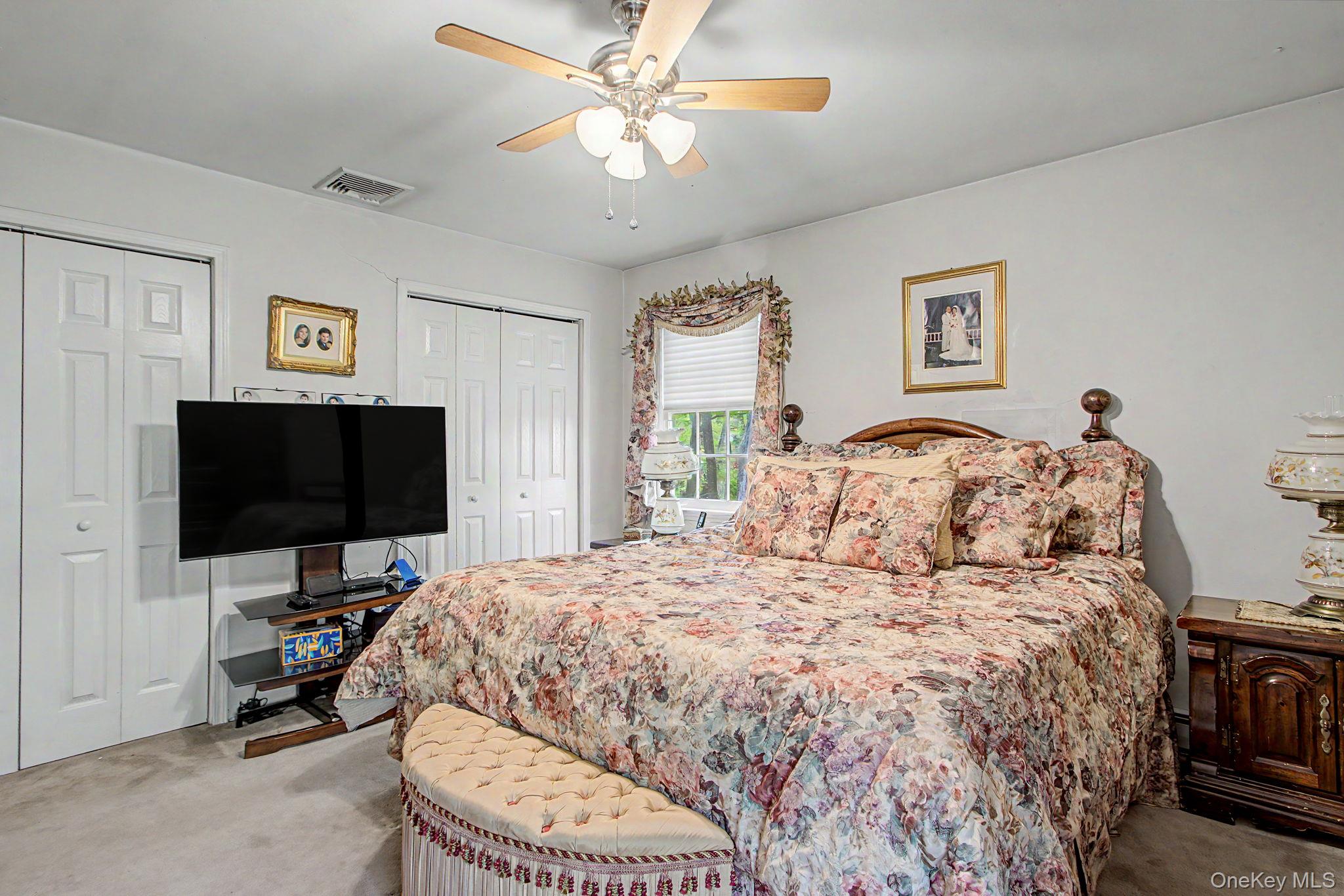 26 Garden Road Mahopac, NY 10541 - Photo 15 of 30 a bedroom with a bed and a flat screen tv