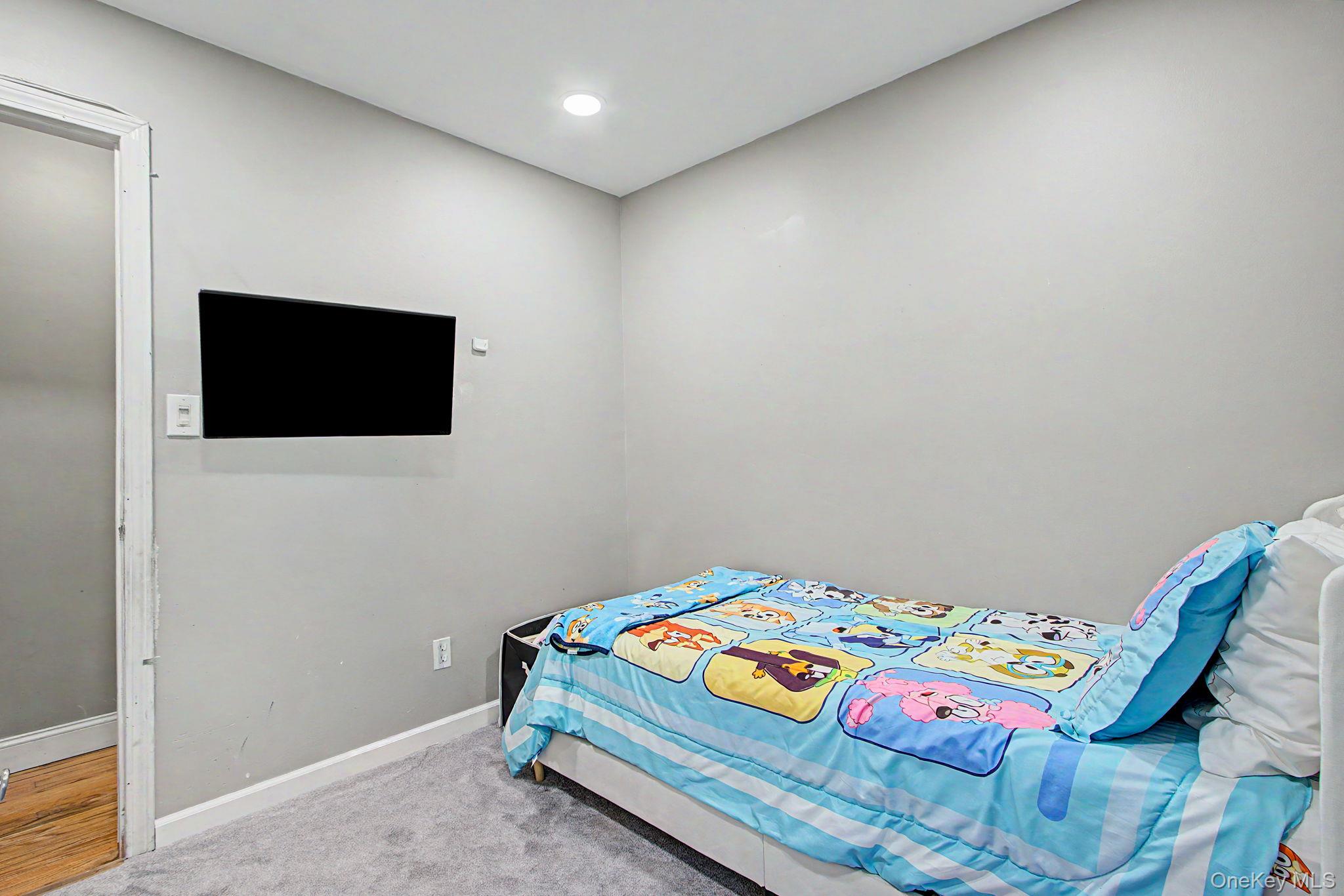 26 Garden Road Mahopac, NY 10541 - Photo 17 of 30 a bedroom with a bed and a flat screen tv