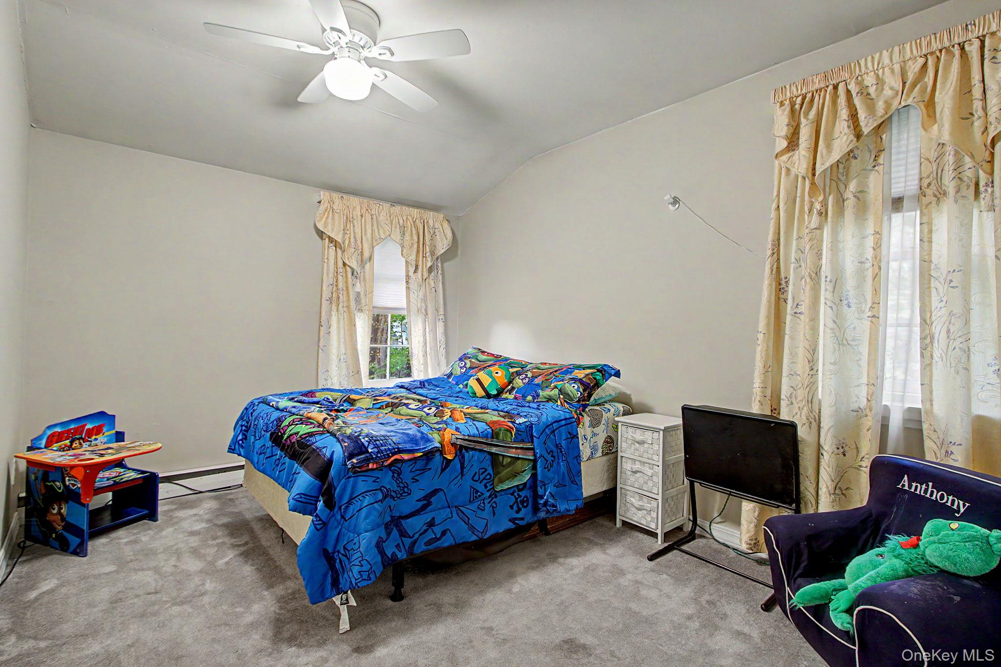 26 Garden Road Mahopac, NY 10541 - Photo 18 of 30 a bedroom with a bed and a chandelier