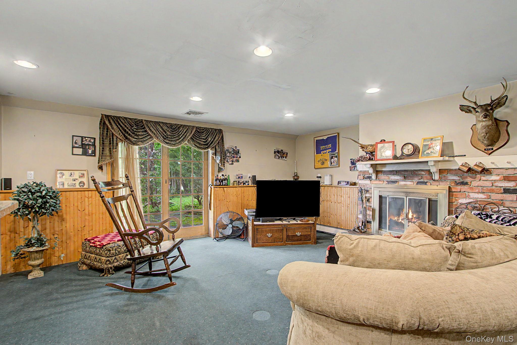 26 Garden Road Mahopac, NY 10541 - Photo 20 of 30 a living room with furniture and a flat screen tv