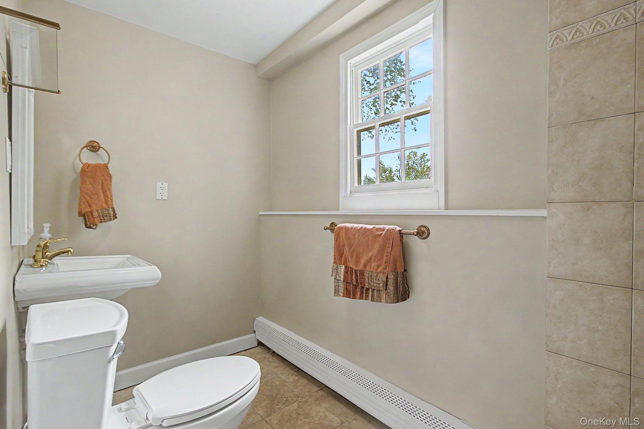 26 Garden Road Mahopac, NY 10541 - Photo 22 of 30 a white toilet sitting next to a bathroom sink