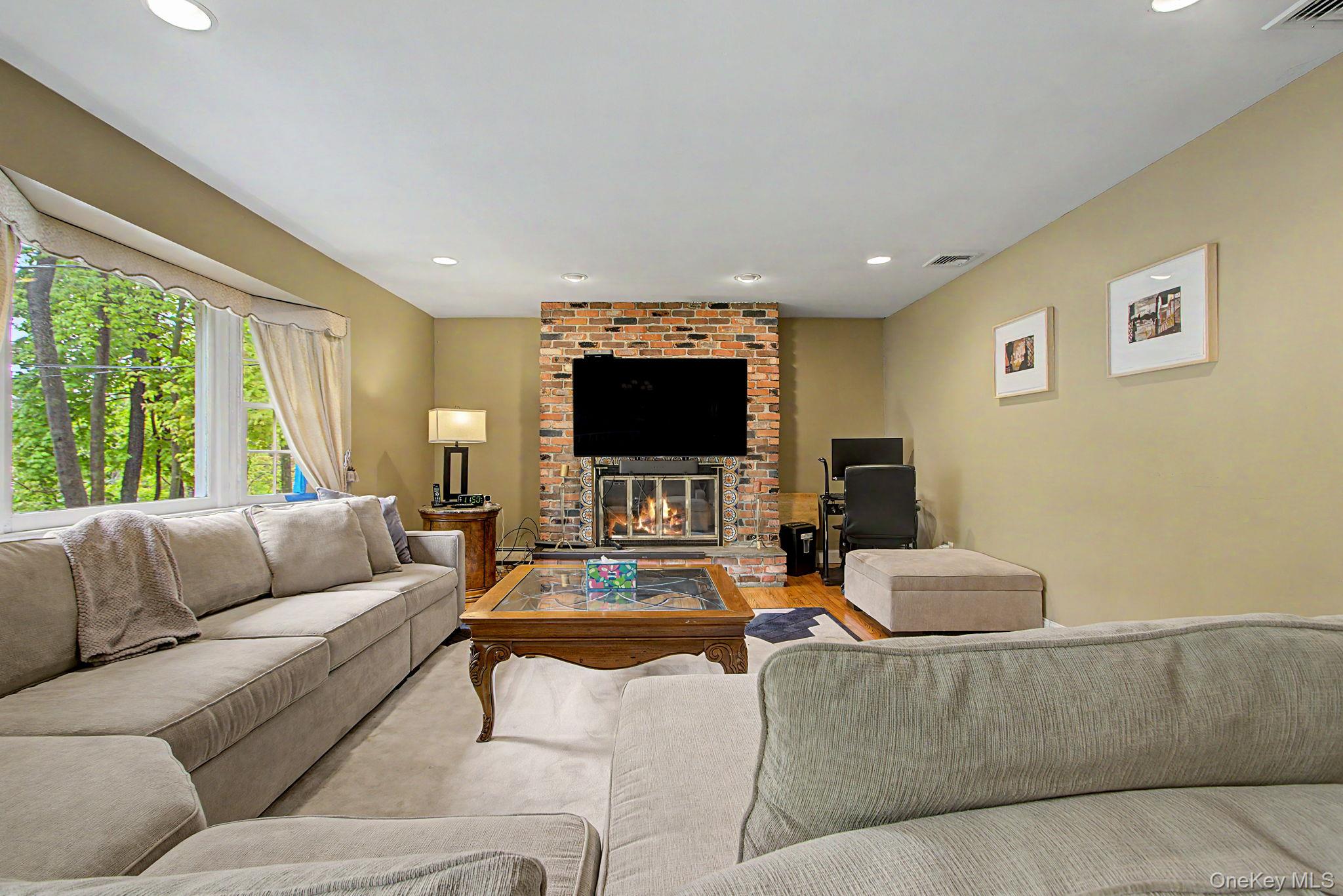 26 Garden Road Mahopac, NY 10541 - Photo 4 of 30 a living room with furniture and a flat screen tv