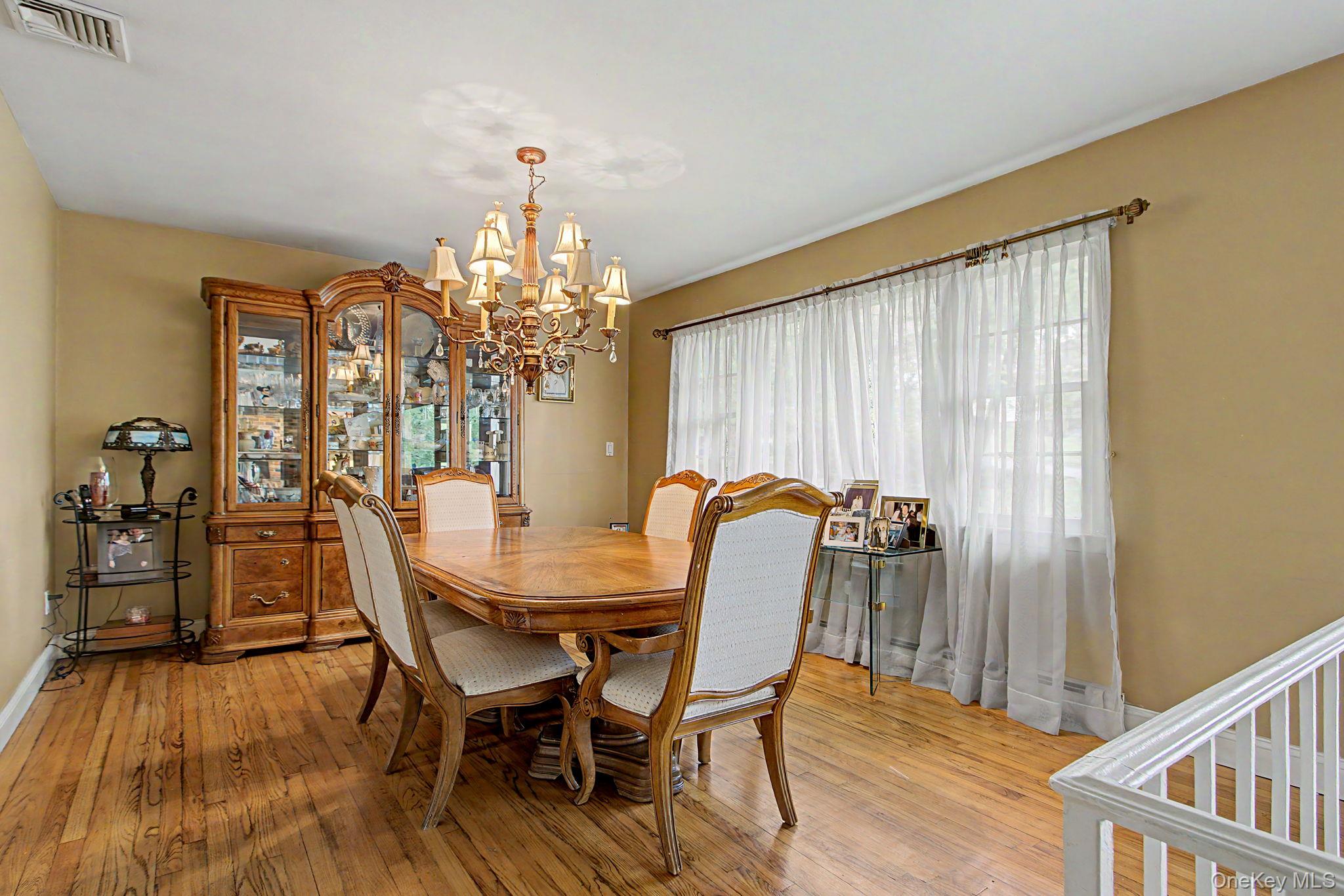 26 Garden Road Mahopac, NY 10541 - Photo 5 of 30 a dining room with furniture a chandelier and wooden floor