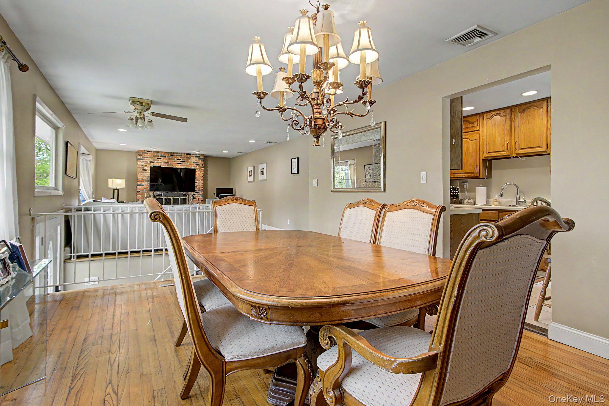 26 Garden Road Mahopac, NY 10541 - Photo 6 of 30 a view of a dining room with furniture a chandelier and wooden floor