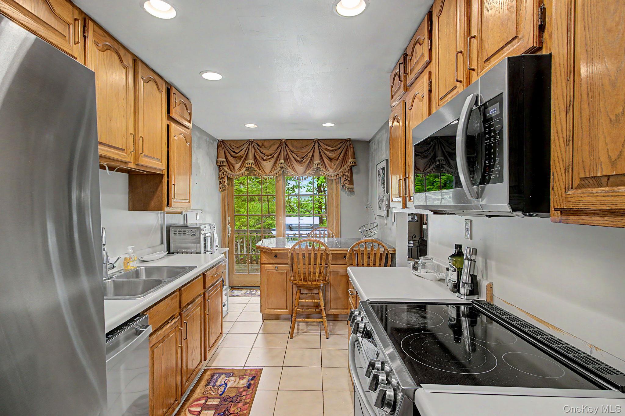 26 Garden Road Mahopac, NY 10541 - Photo 7 of 30 a kitchen with a sink a counter top space and stainless steel appliances