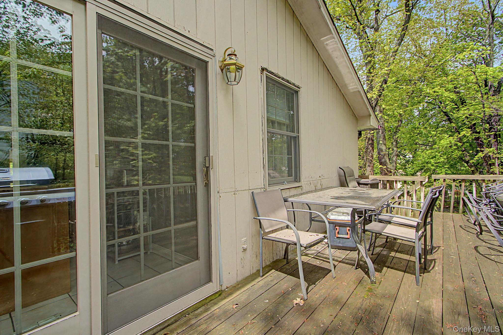 26 Garden Road Mahopac, NY 10541 - Photo 9 of 30 a patio with table and chairs and potted plants
