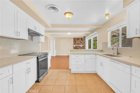 a kitchen with stainless steel appliances granite countertop a sink and a granite counter tops