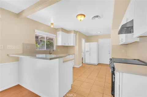 a view of a kitchen with white cabinets