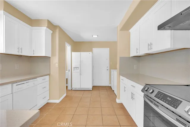 a kitchen with granite countertop white cabinets and a sink