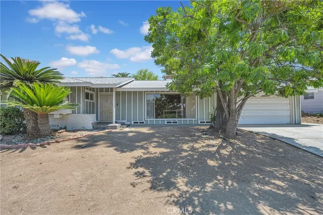 a view of a house with a tree in front