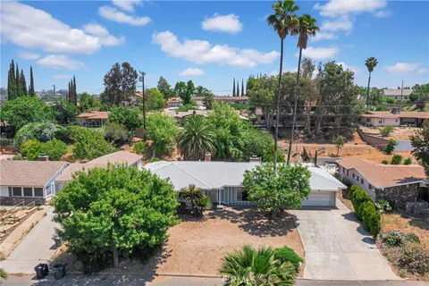 a view of a garden with a building in the background