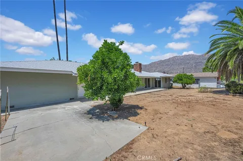 an aerial view of multiple houses with a yard