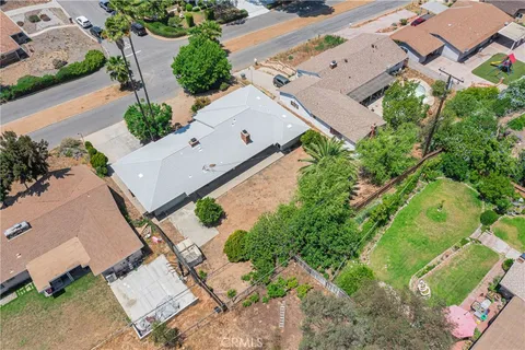 an aerial view of a house with a yard and pool