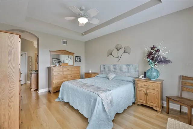 a bedroom with a bed and a chandelier