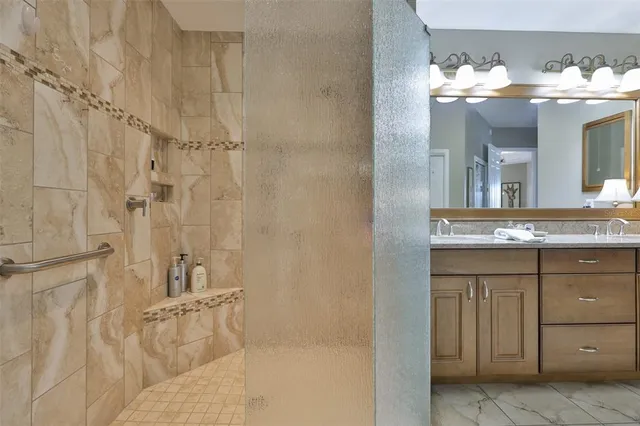 a bathroom with a sink vanity and mirror
