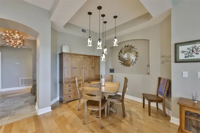 a view of a dining room with furniture and chandelier