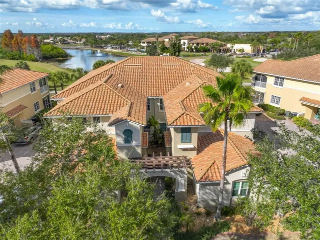 an aerial view of a house with a yard and lake view