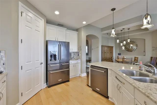 a kitchen with a sink refrigerator and microwave
