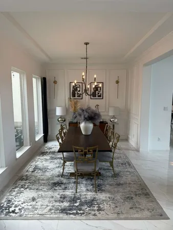 a dining room with furniture a rug and wooden floor