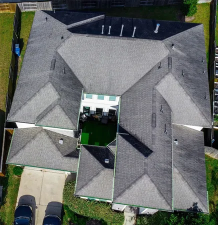 an aerial view of a house with a yard