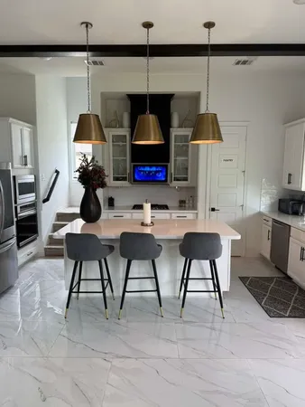 a living room with chairs a table and chairs