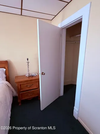 a view of a bedroom with a bed