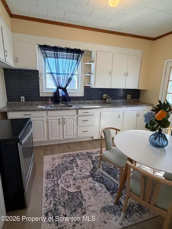 a kitchen with a sink cabinets and window