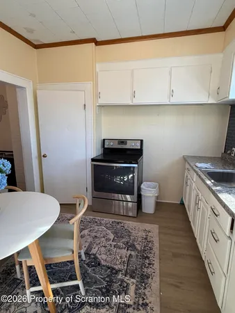 a kitchen with a wooden cabinets and stove