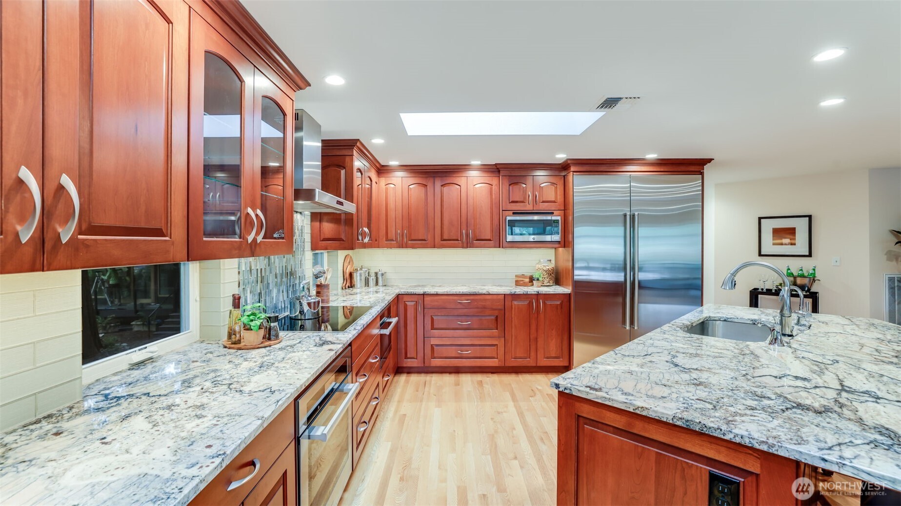 2171 North 122nd Place Seattle, WA 98133 - Photo 14 of 40 a kitchen with stainless steel appliances granite countertop a sink and counter space