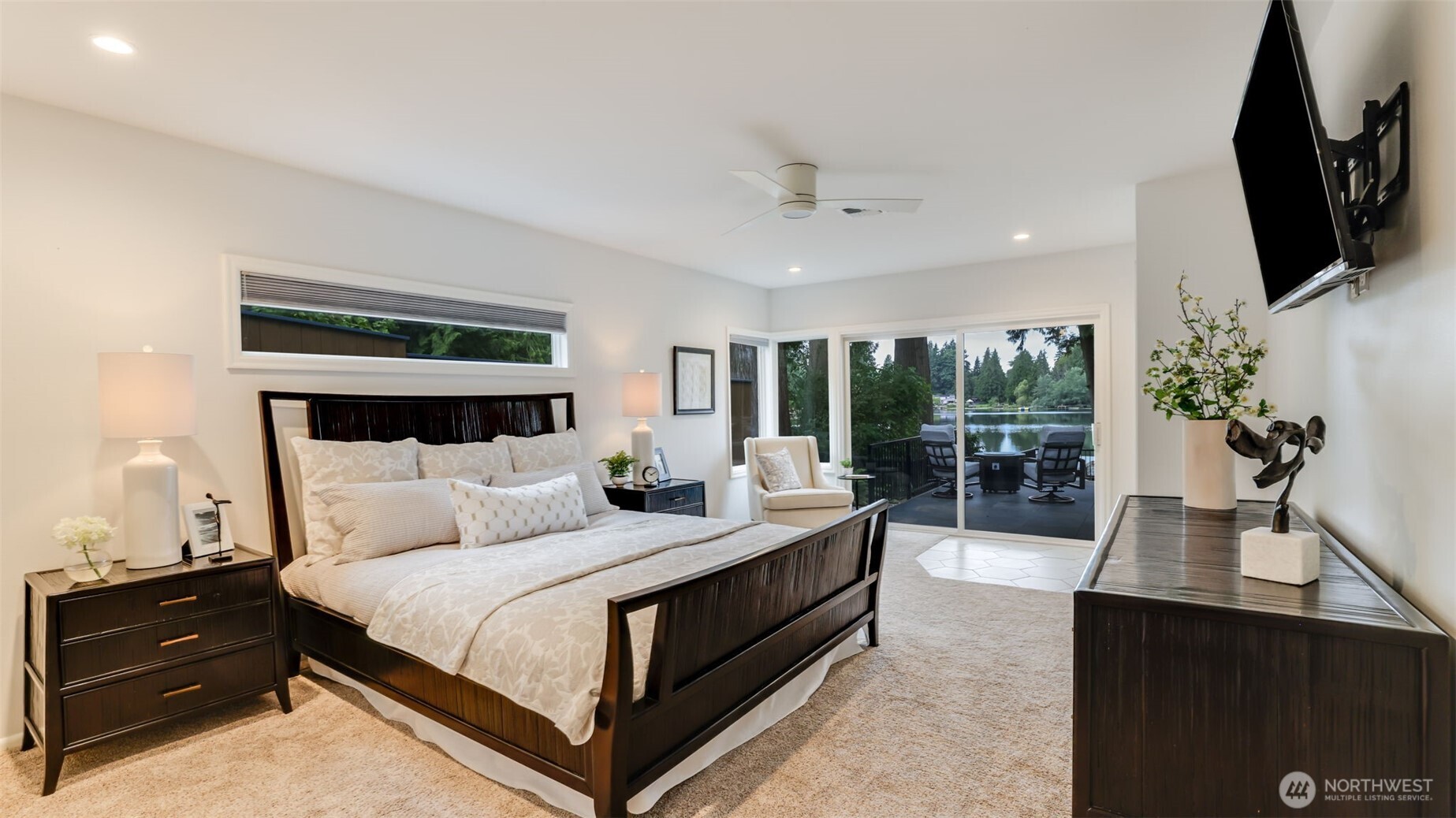 2171 North 122nd Place Seattle, WA 98133 - Photo 20 of 40 a bedroom with a bed a flat screen tv and a large window