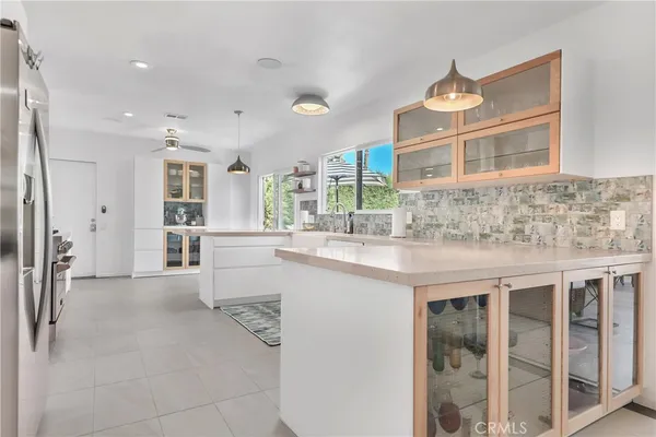 a kitchen with kitchen island granite countertop a sink and cabinets