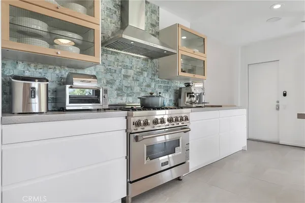 a kitchen with stainless steel appliances granite countertop white cabinets and window