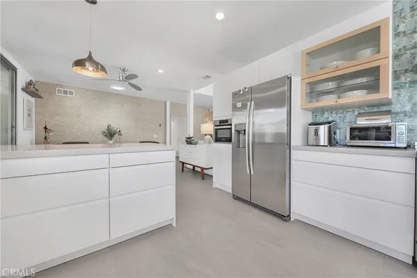 a kitchen with a refrigerator and a sink