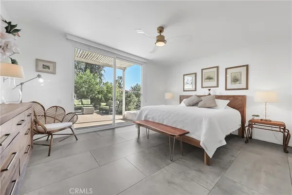 a spacious bedroom with a bed and a couch