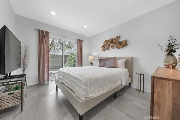 a bedroom with a bed and a flat screen television