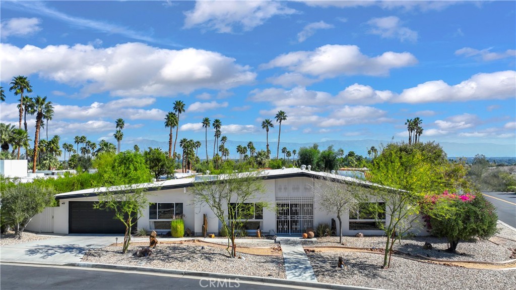 71620 Halgar Road Rancho Mirage, CA 92270 - Photo 2 of 41 a view of a house with a porch and a garden