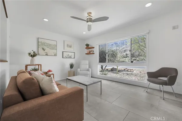 a living room with furniture and a large window