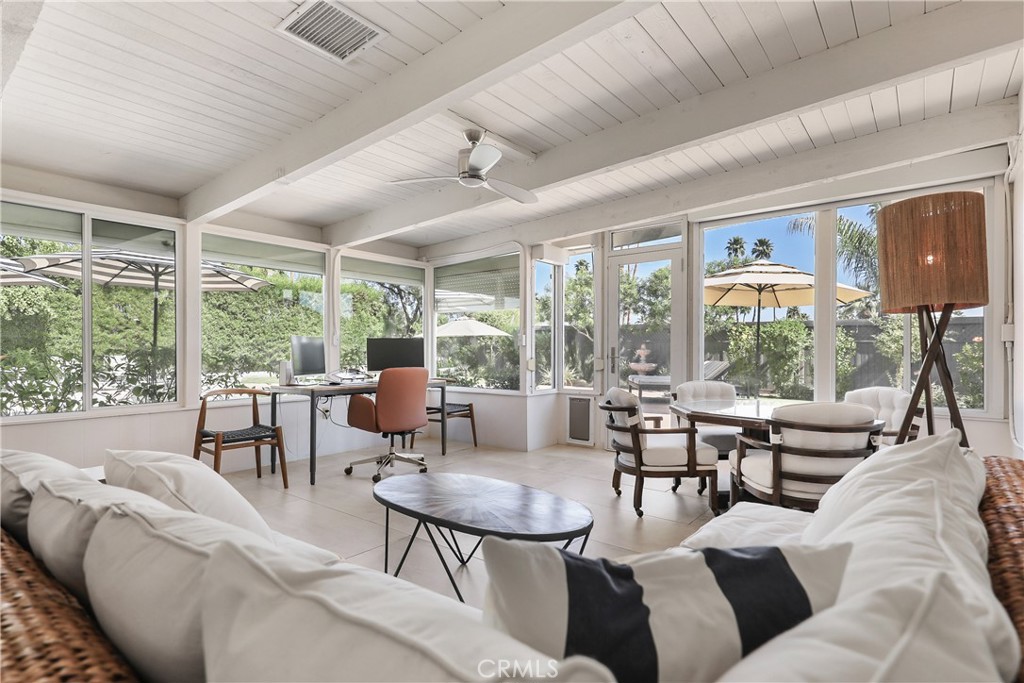 71620 Halgar Road Rancho Mirage, CA 92270 - Photo 25 of 41 a living room with furniture large windows and wooden floor