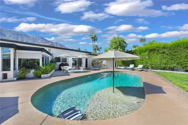a view of a house with backyard porch and sitting area