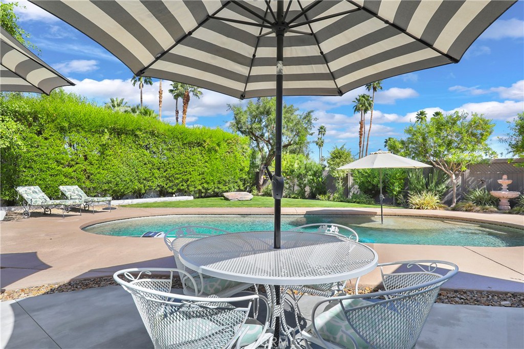 71620 Halgar Road Rancho Mirage, CA 92270 - Photo 34 of 41 a patio with a table and chairs under an umbrella