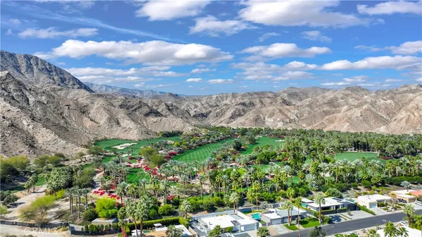 a view of a city with lush green forest