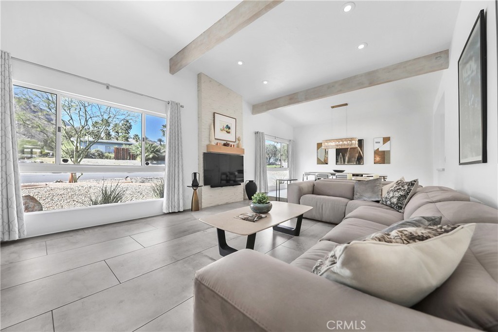 71620 Halgar Road Rancho Mirage, CA 92270 - Photo 9 of 41 a living room with furniture and a flat screen tv