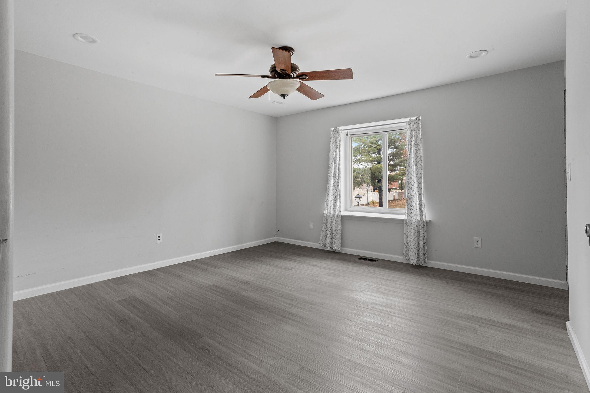 121 Aspen Court Marlton, NJ 08053 - Photo 12 of 22 a view of an empty room with wooden floor and a window