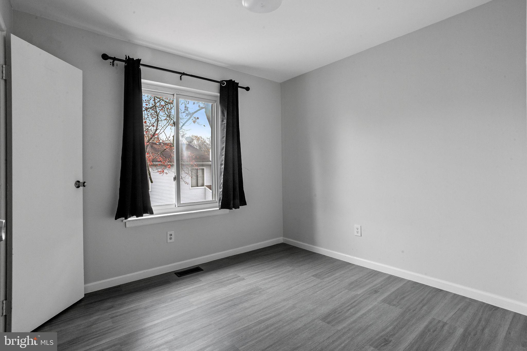 121 Aspen Court Marlton, NJ 08053 - Photo 22 of 22 a view of an empty room with wooden floor and a window