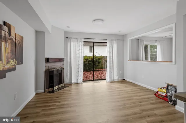 a view of a livingroom with an entryway and a fireplace
