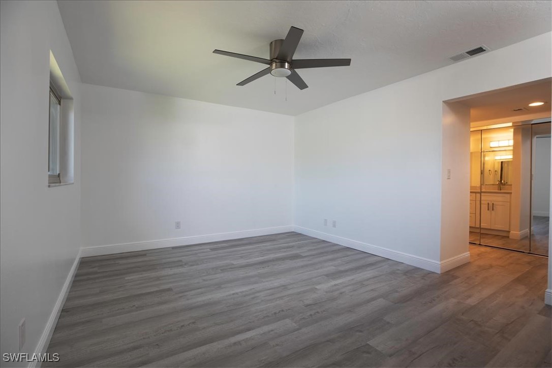 16620 Partridge Place Road, Unit 202 Fort Myers, FL 33908 - Photo 13 of 27 a view of a room with wooden floor and a ceiling fan
