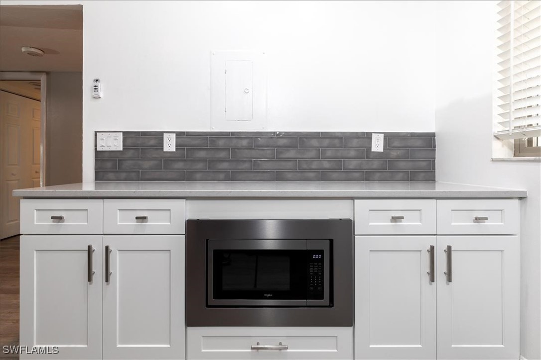 16620 Partridge Place Road, Unit 202 Fort Myers, FL 33908 - Photo 8 of 27 a stove top oven sitting inside of a kitchen