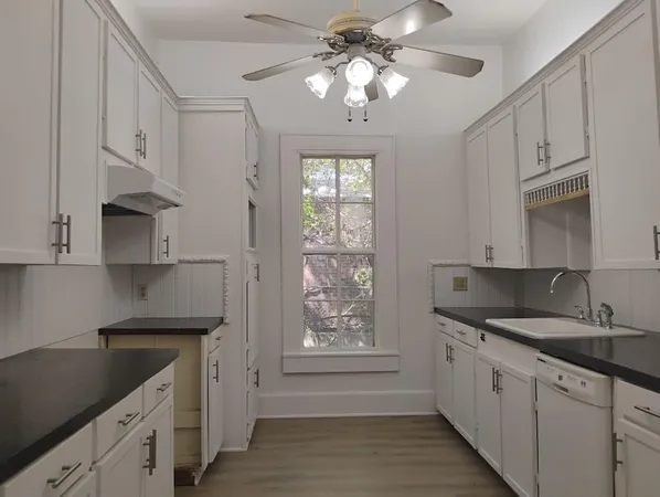 a kitchen with stainless steel appliances granite countertop a sink a stove and a refrigerator