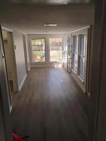 wooden floor in an empty room with a window