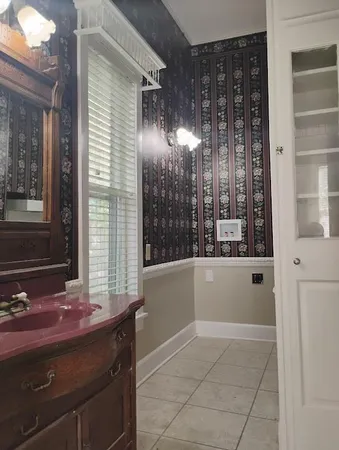 a bathroom with a tub sink and mirror
